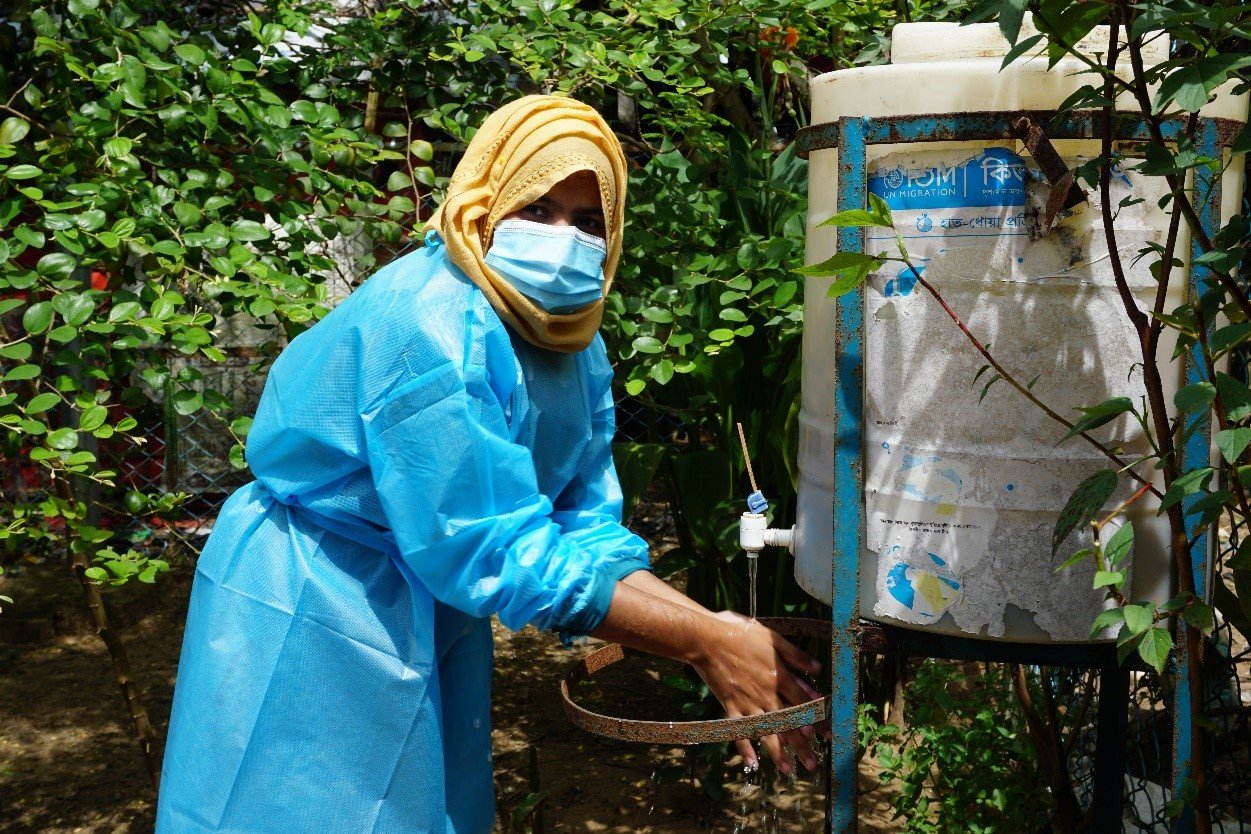 A midwife at IOM Health Post, Marina Akter using the handwashing station before attending to the labour
