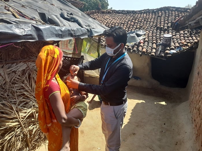 healthcare worker administering a vaccine to a child